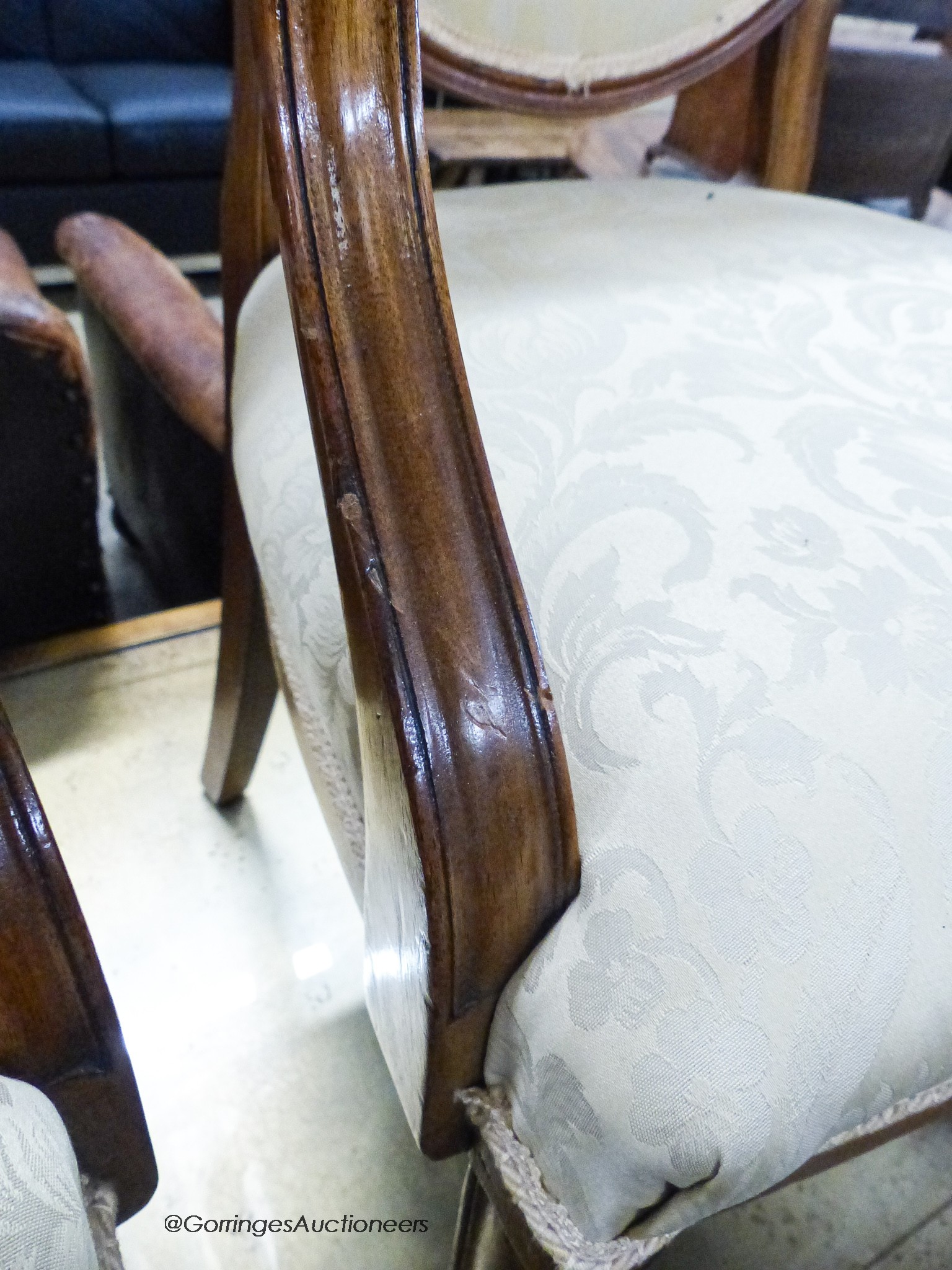 A pair of upholstered elbow chairs, width 57cm, height 100cm